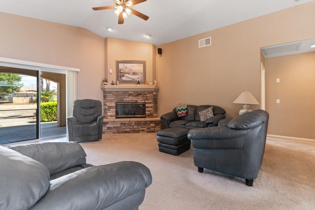 575 Rancho Trail Ramona, CA 92065 - Photo 26 of 47 a living room with furniture a fireplace and a large window