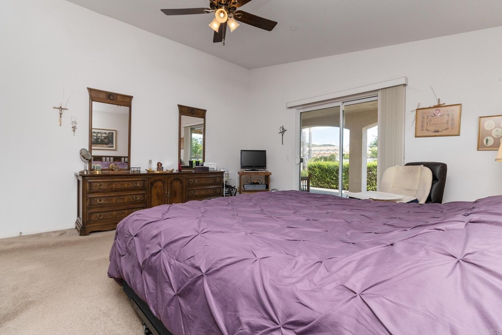 575 Rancho Trail Ramona, CA 92065 - Photo 29 of 47 a bedroom with a bed and a chandelier