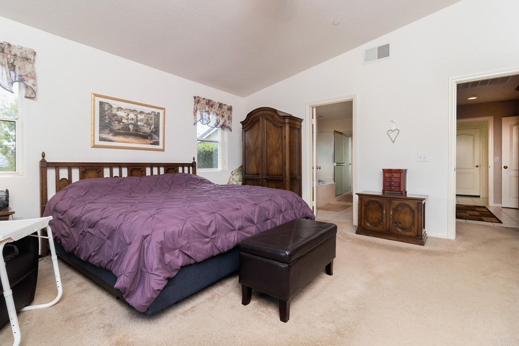 575 Rancho Trail Ramona, CA 92065 - Photo 30 of 47 a spacious bedroom with a bed and couch