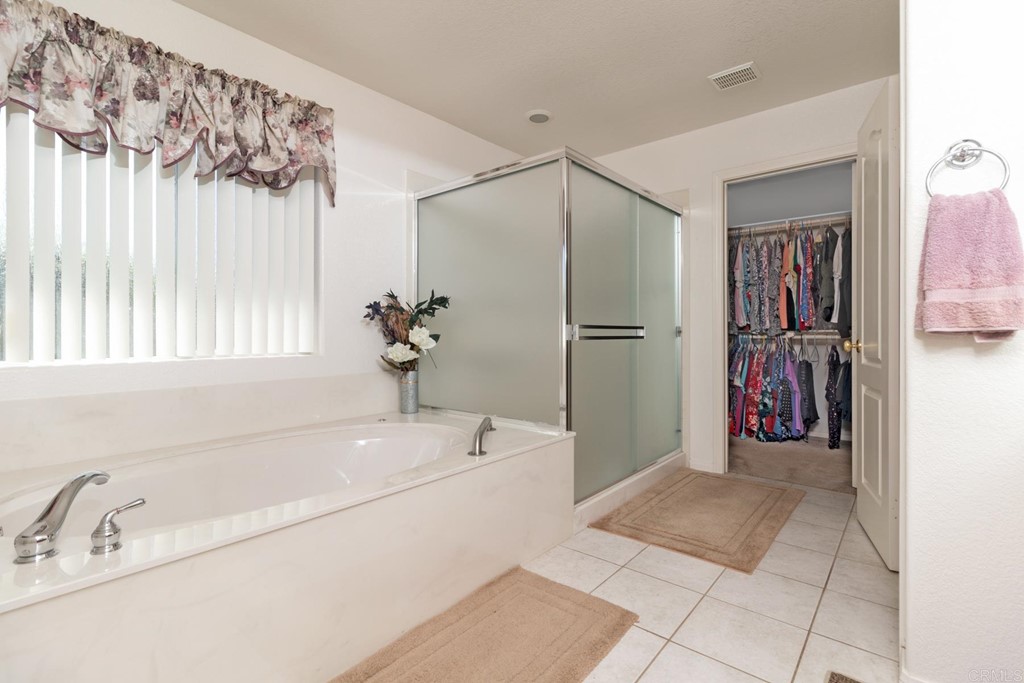 575 Rancho Trail Ramona, CA 92065 - Photo 31 of 47 a bathroom with a tub and a shower