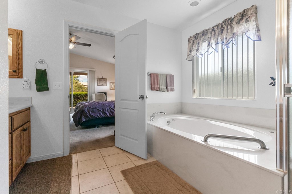 575 Rancho Trail Ramona, CA 92065 - Photo 33 of 47 a en suite spacious bathroom with a granite countertop tub and a sink