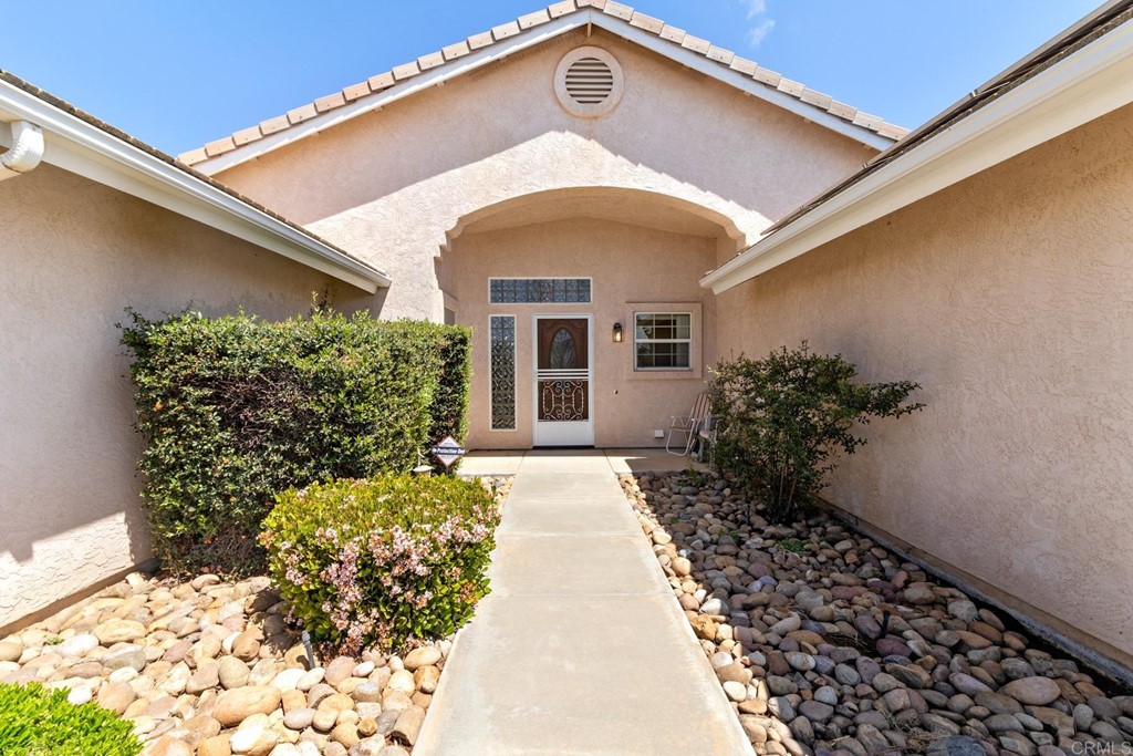 575 Rancho Trail Ramona, CA 92065 - Photo 4 of 47 a front view of a house with garden