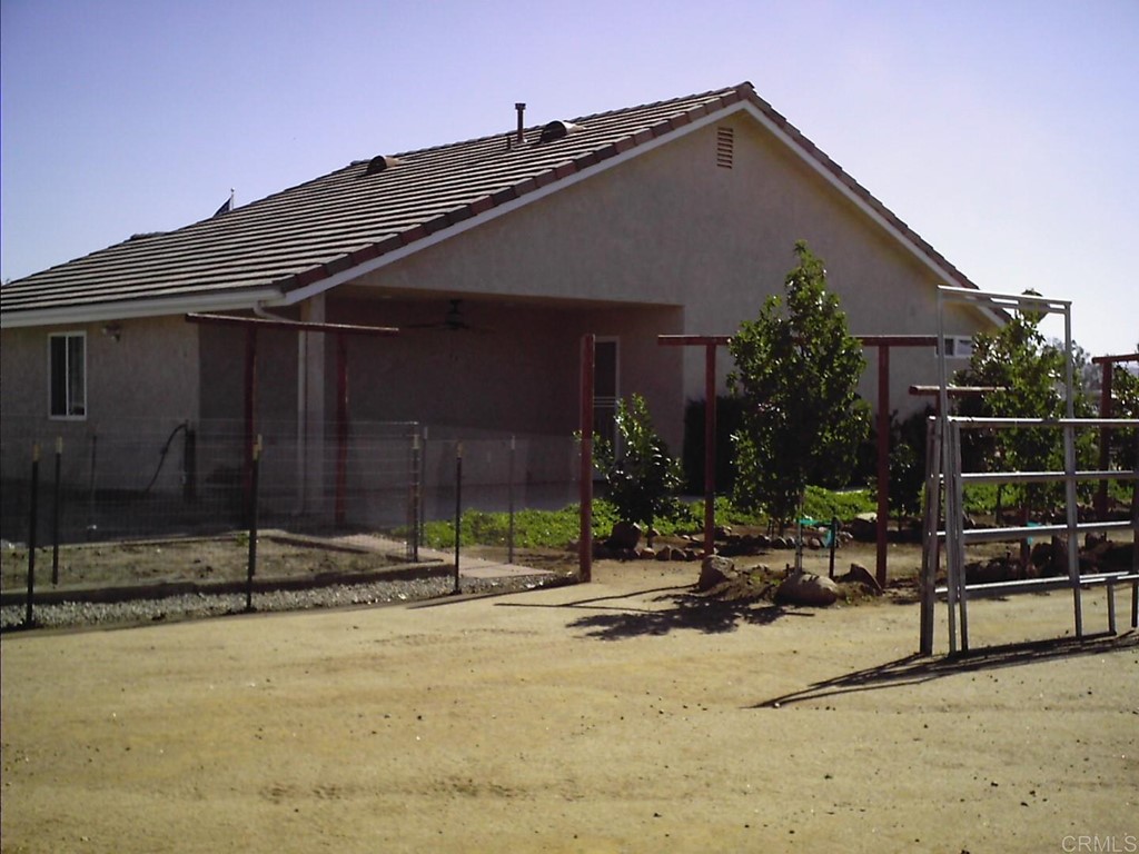 575 Rancho Trail Ramona, CA 92065 - Photo 43 of 47 a backyard of a house with barbeque oven table and chairs