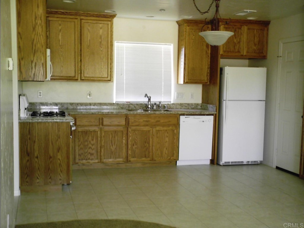 575 Rancho Trail Ramona, CA 92065 - Photo 45 of 47 a kitchen with a sink cabinets and appliances