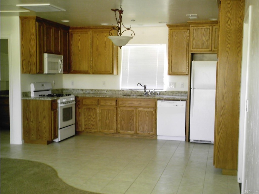 575 Rancho Trail Ramona, CA 92065 - Photo 46 of 47 a kitchen with stainless steel appliances granite countertop a stove a sink and a refrigerator