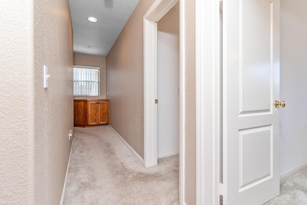 575 Rancho Trail Ramona, CA 92065 - Photo 9 of 47 a view of a hallway with wooden shelves