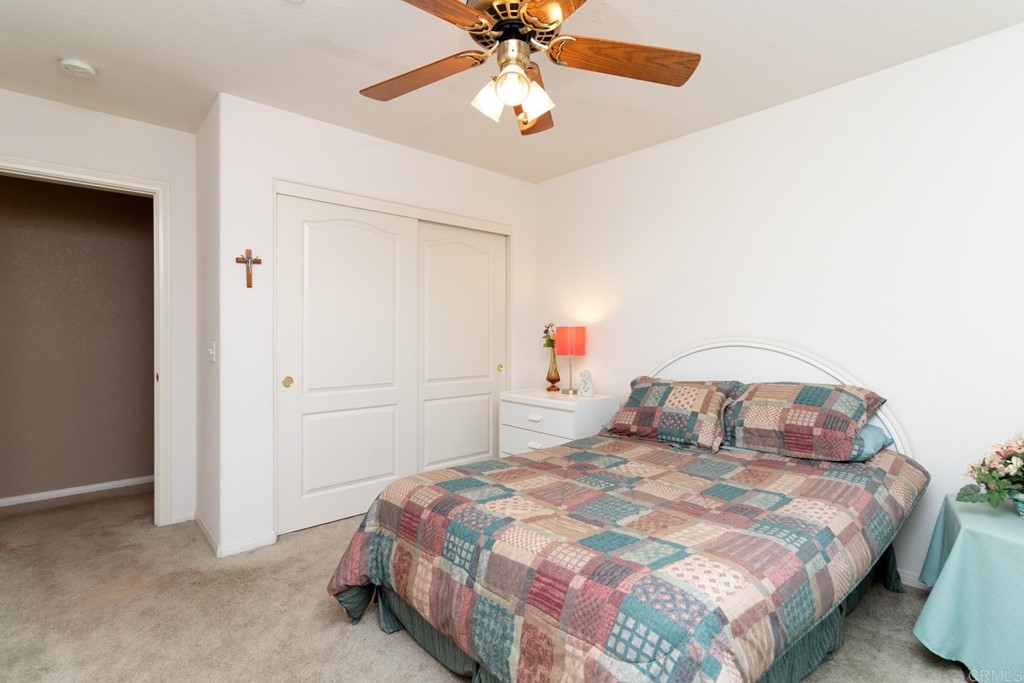 575 Rancho Trail Ramona, CA 92065 - Photo 10 of 47 a bedroom with a bed and a chandelier