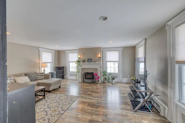 a living room with furniture a fireplace and a flat screen tv