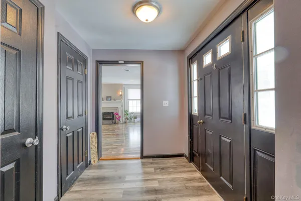 a view of a hallway with wooden shelves