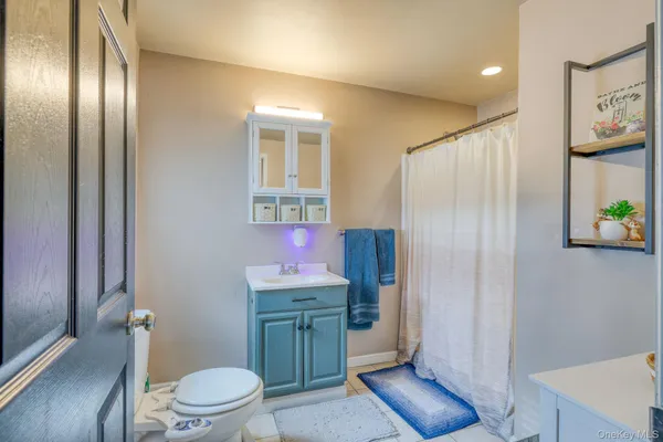 a bathroom with a toilet sink and shower