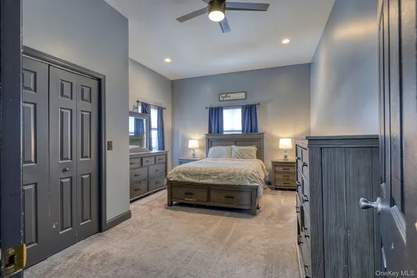 a spacious bedroom with a bed and a chandelier