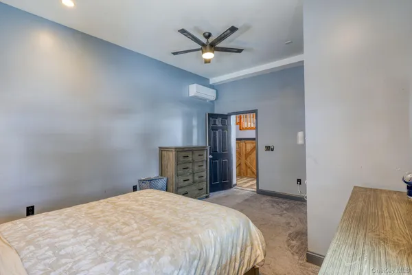 a bedroom with a bed and a ceiling fan