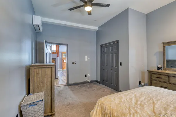 a bedroom with a bed and a chair