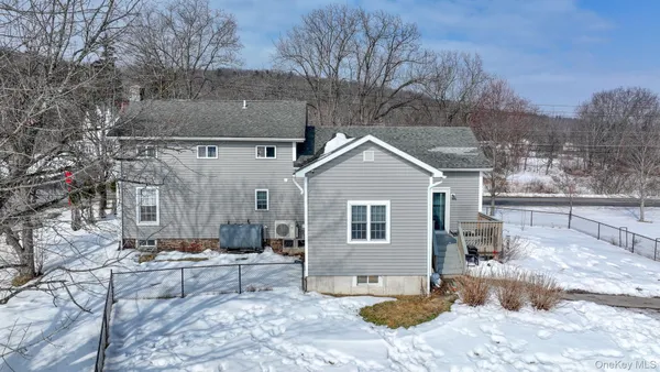 a view of a house with a yard covered in snow