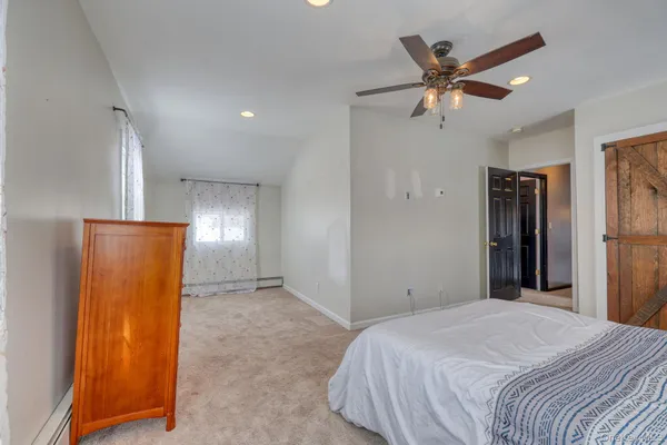 a bedroom with a bed and a mirror