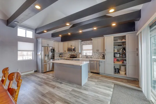 a kitchen with refrigerator and cabinets