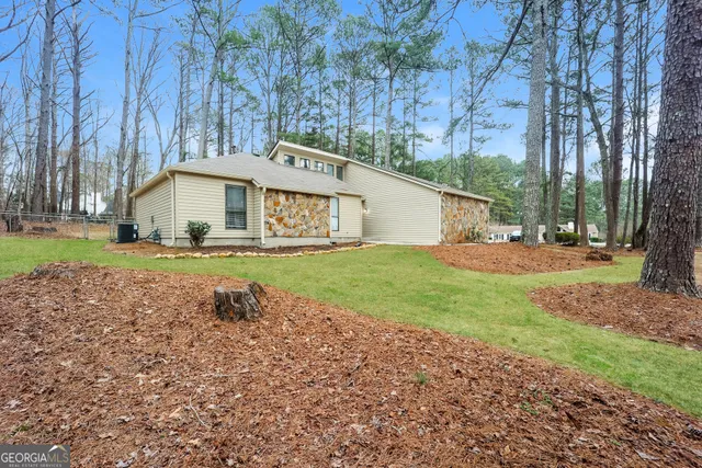 a white house that has a tree in front of it