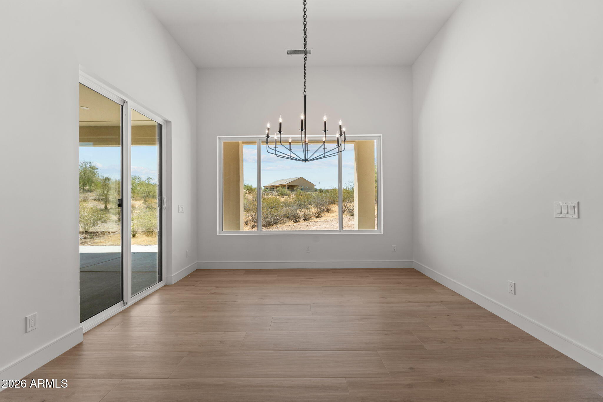 2855 Percheron Road Wickenburg, AZ 85390 - Photo 32 of 58 a view of a room with window wooden floor and chandelier