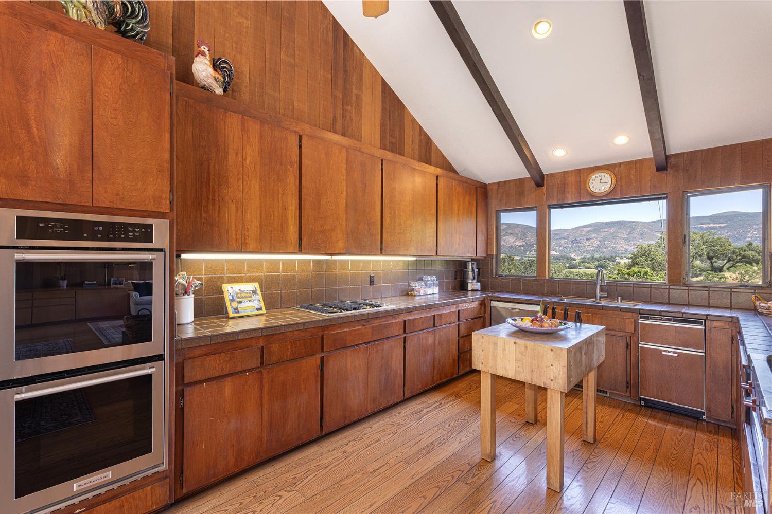 2231 First Avenue Napa, CA 94558 - Photo 13 of 64 a kitchen with stainless steel appliances kitchen island granite countertop a stove a sink and a microwave