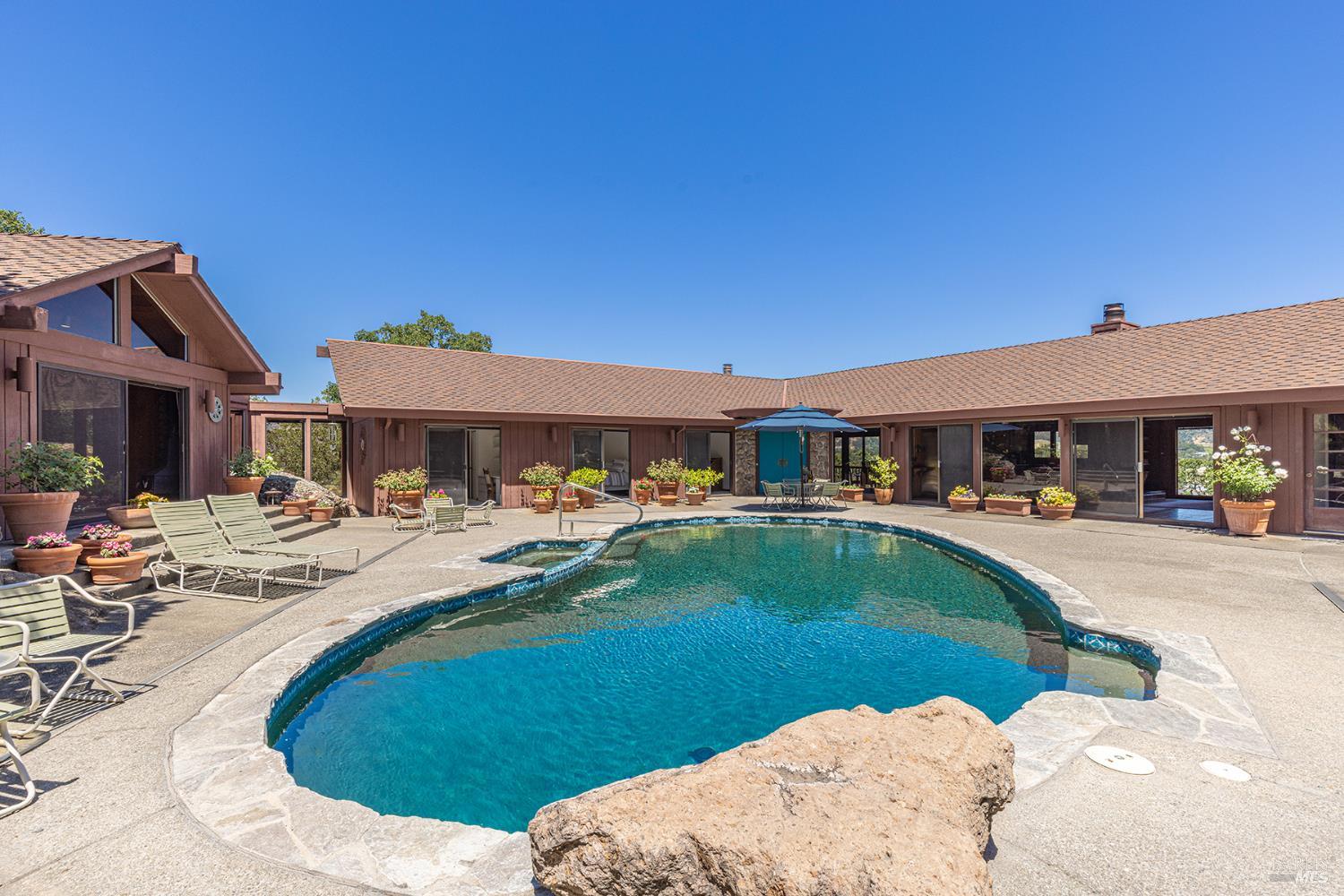 2231 First Avenue Napa, CA 94558 - Photo 7 of 64 a front view of a house with swimming pool having outdoor seating