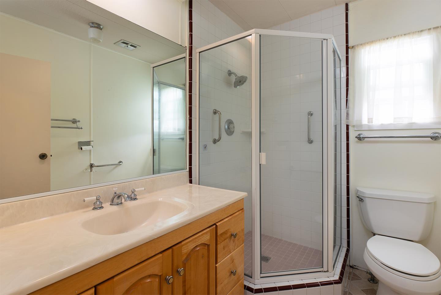 7 Oak Shadows Lane Aptos, CA 95003 - Photo 18 of 36 a bathroom with a shower sink vanity mirror and toilet