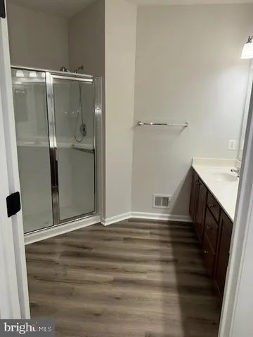 a kitchen with wooden floors and white appliances