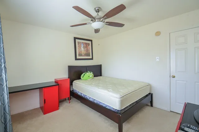 a bedroom with a bed and a table