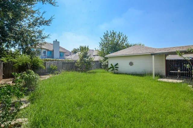 a view of a house with a backyard and swimming pool