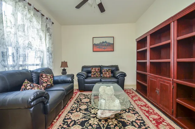 a living room with furniture and a rug