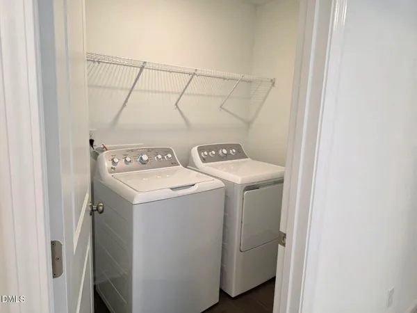a view of a sink and dishwasher with wooden floor