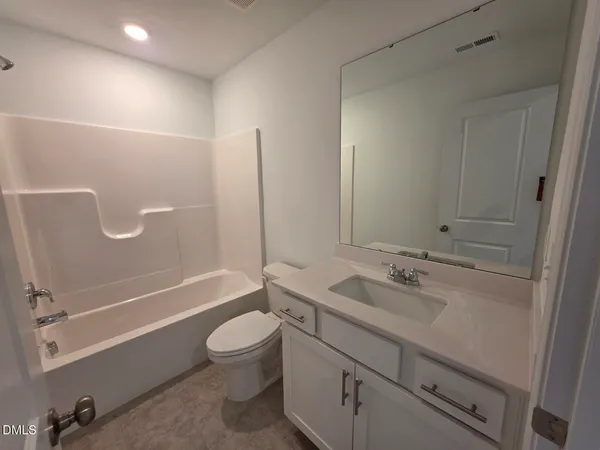 a view of a living room with furniture and wooden floor