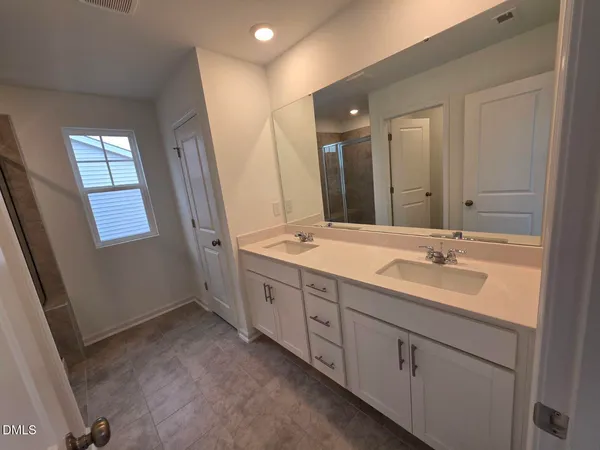 a bathroom with a granite countertop toilet and a sink