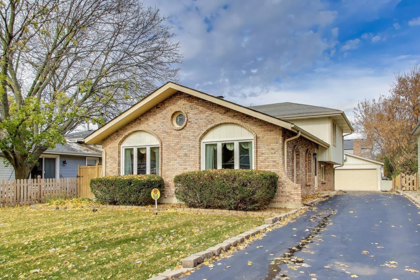 1407 Wilson Avenue Wheaton, IL 60189 - Photo 1 of 31 a front view of a house with a yard