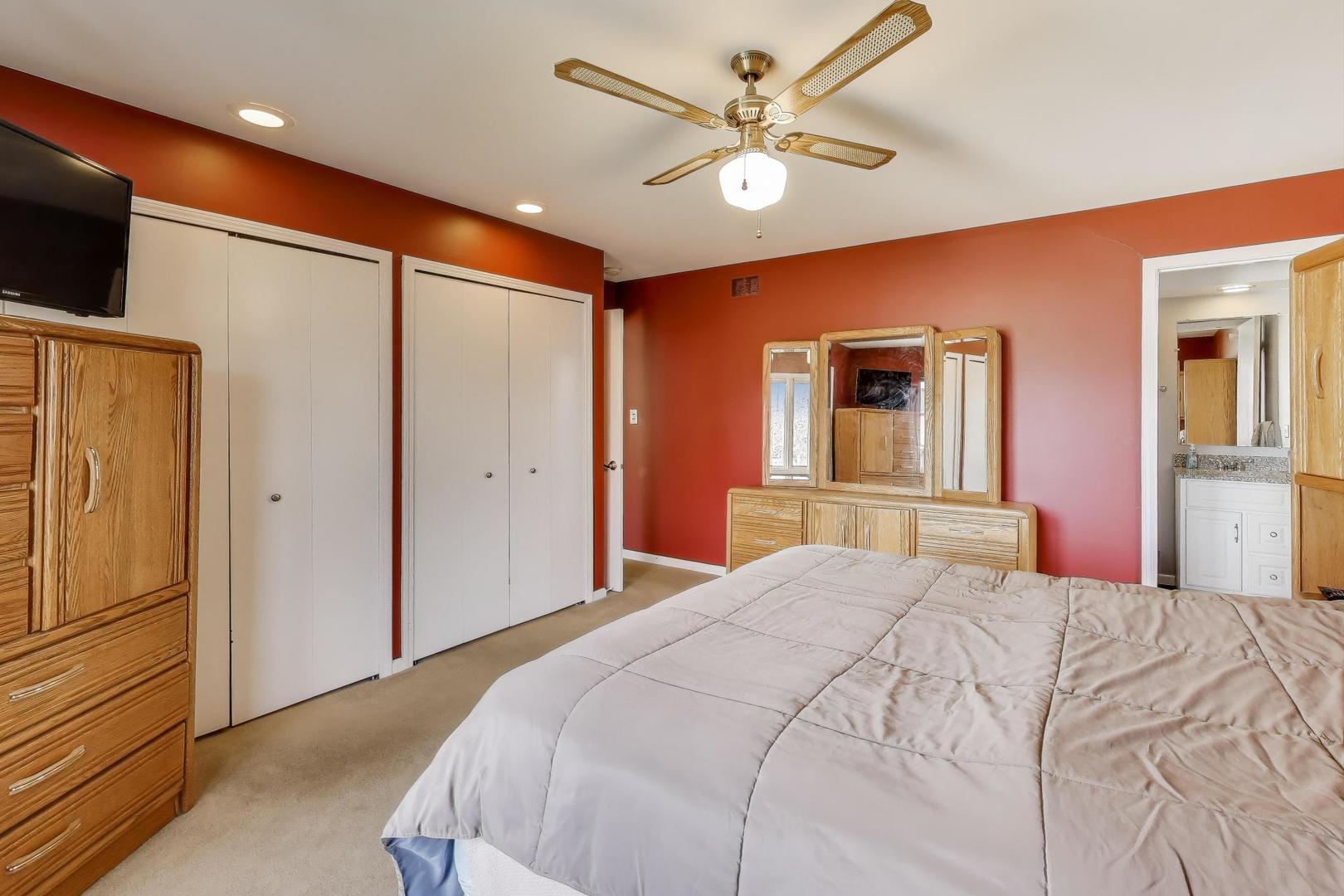 1407 Wilson Avenue Wheaton, IL 60189 - Photo 12 of 31 a bedroom with a large bed and a chandelier