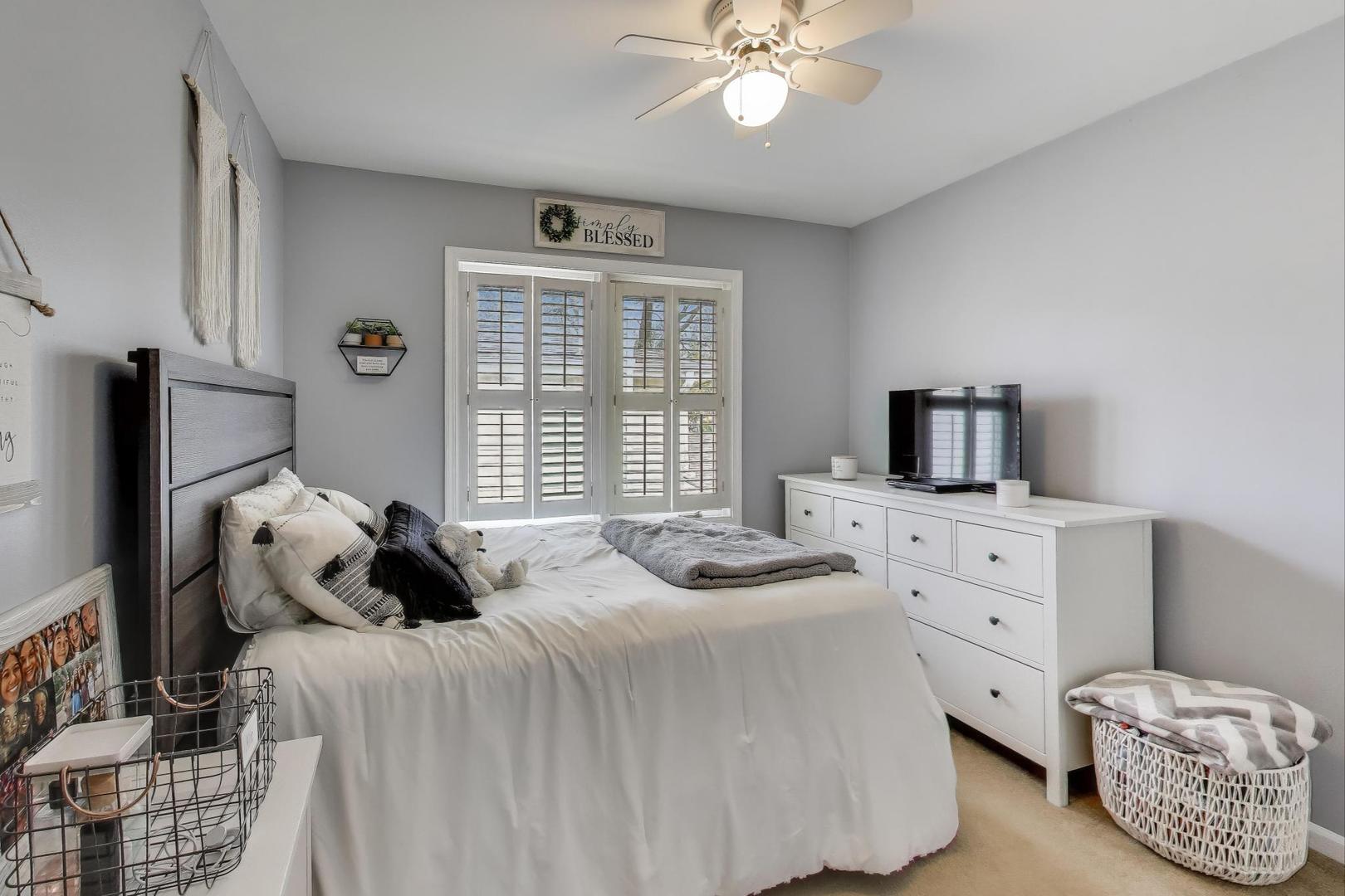 1407 Wilson Avenue Wheaton, IL 60189 - Photo 16 of 31 a bedroom with a bed and a chandelier