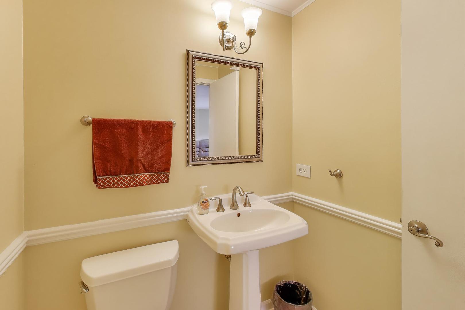 1407 Wilson Avenue Wheaton, IL 60189 - Photo 24 of 31 a bathroom with a sink a toilet and mirror