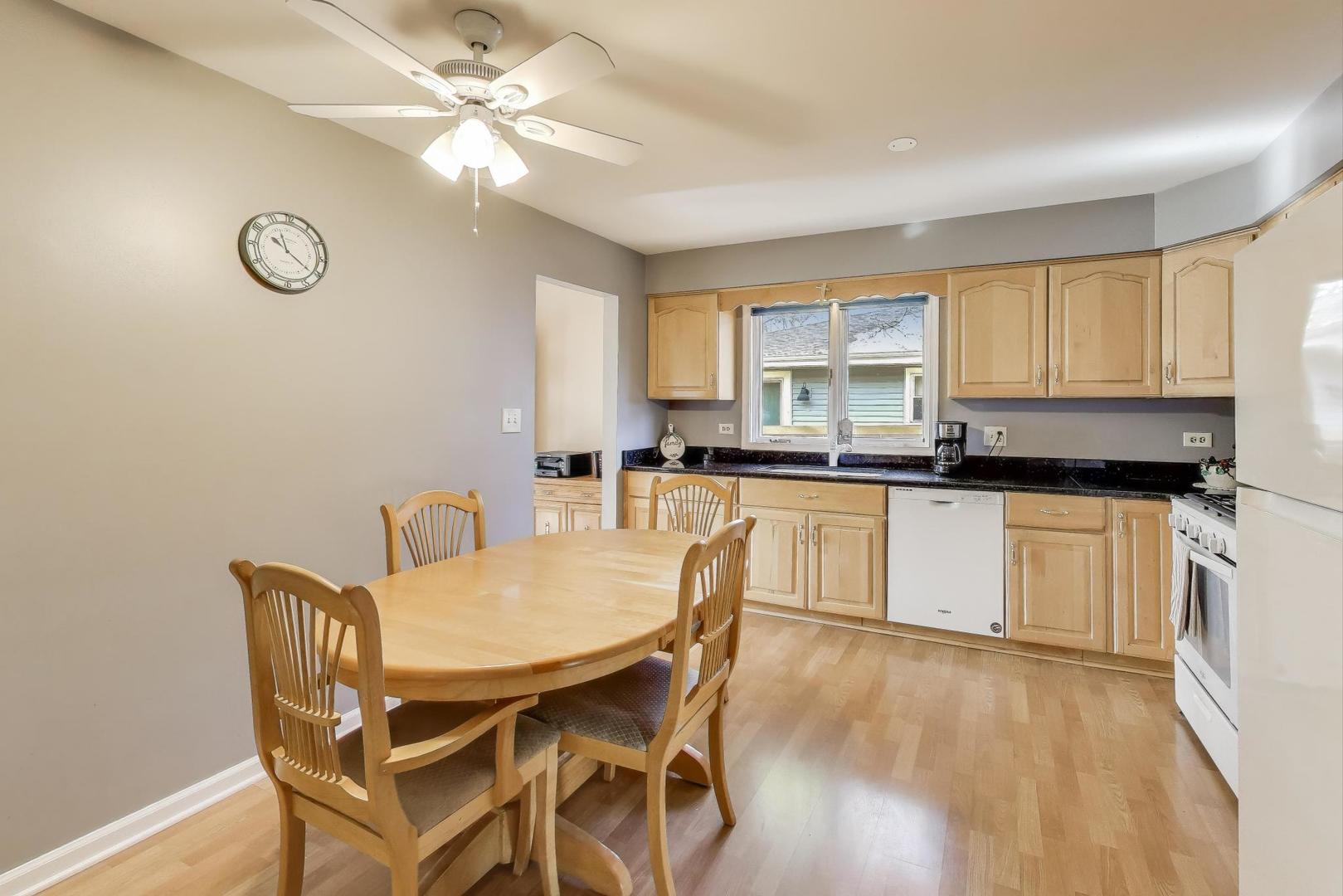 1407 Wilson Avenue Wheaton, IL 60189 - Photo 5 of 31 a kitchen with granite countertop white cabinets and black appliances