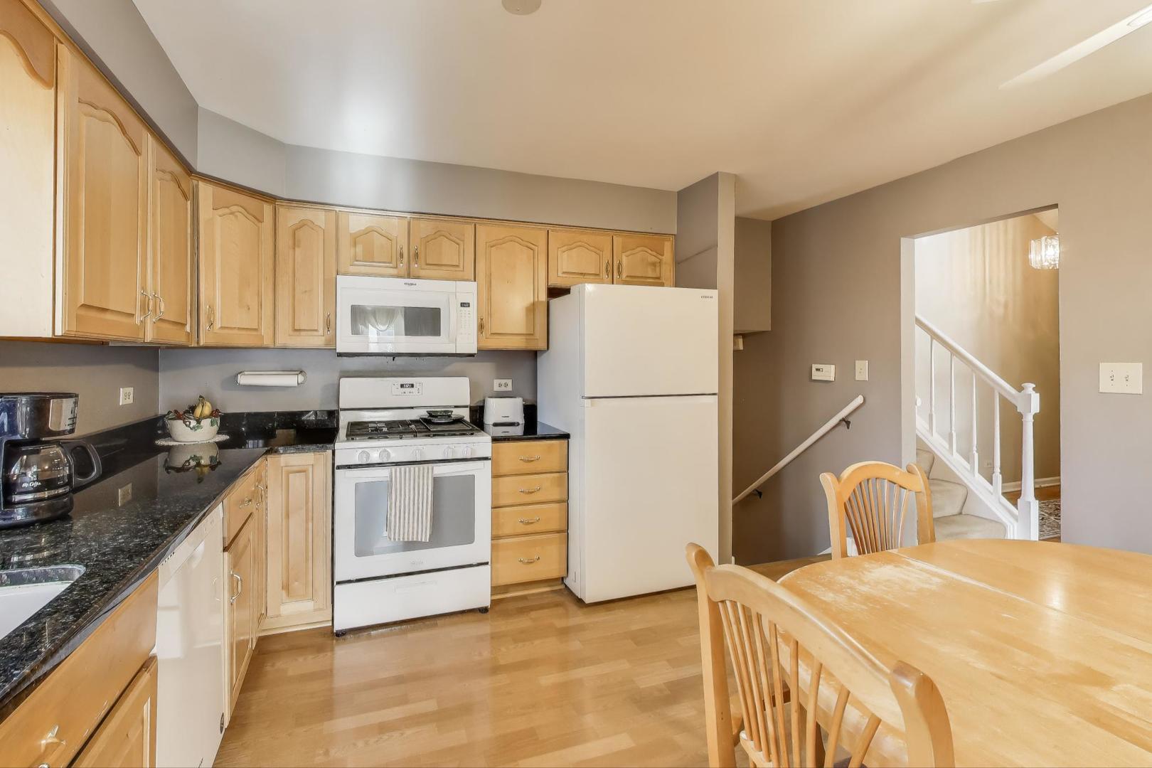 1407 Wilson Avenue Wheaton, IL 60189 - Photo 6 of 31 a kitchen with a sink a stove and a refrigerator