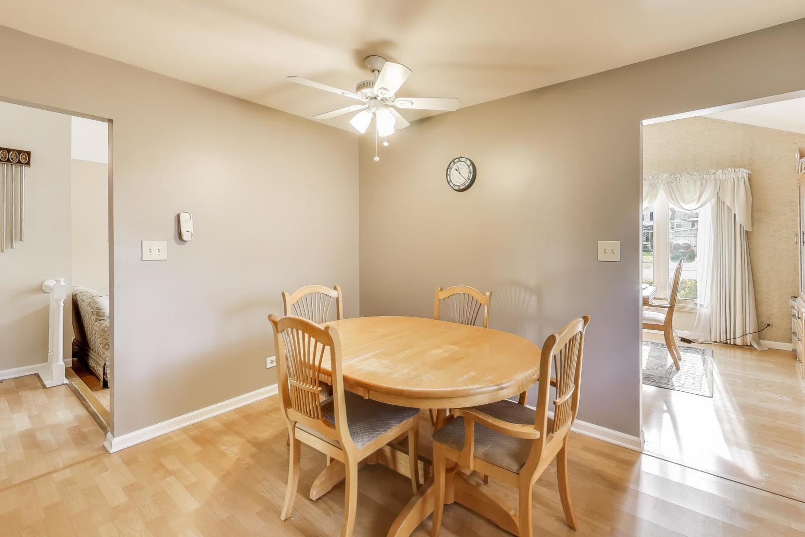 1407 Wilson Avenue Wheaton, IL 60189 - Photo 7 of 31 a view of a dining room with furniture and a chandelier