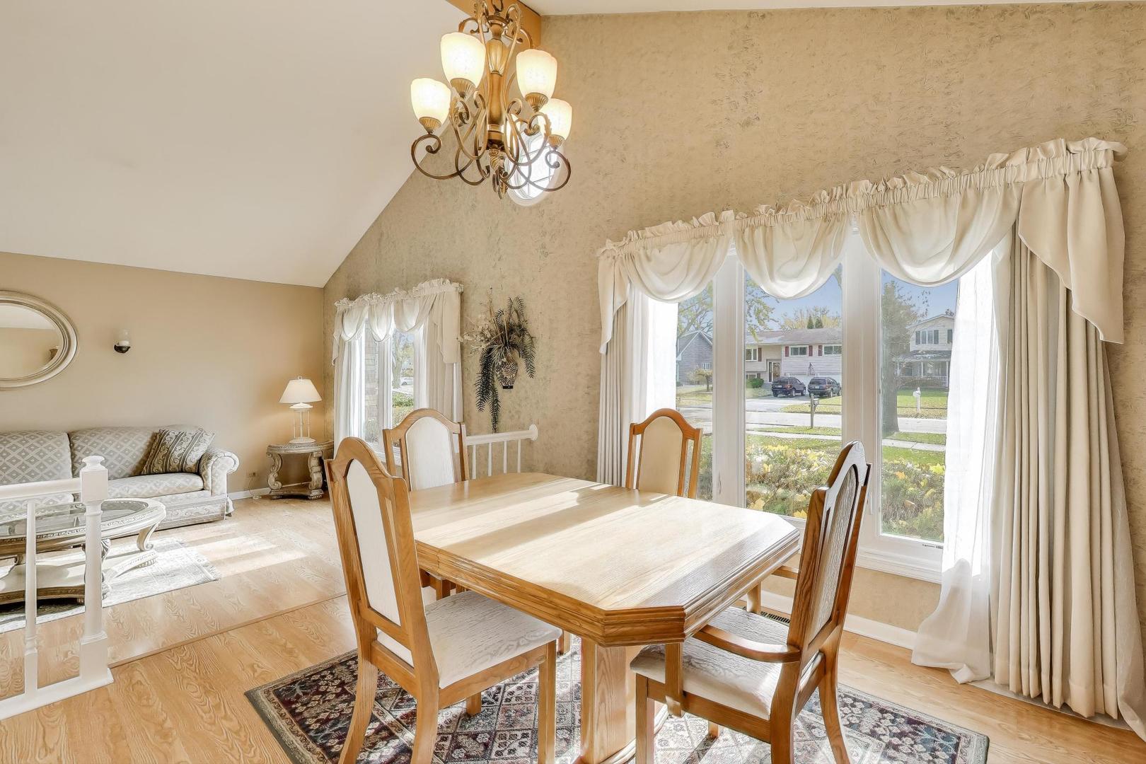 1407 Wilson Avenue Wheaton, IL 60189 - Photo 9 of 31 a view of a dining room with furniture a chandelier and a window
