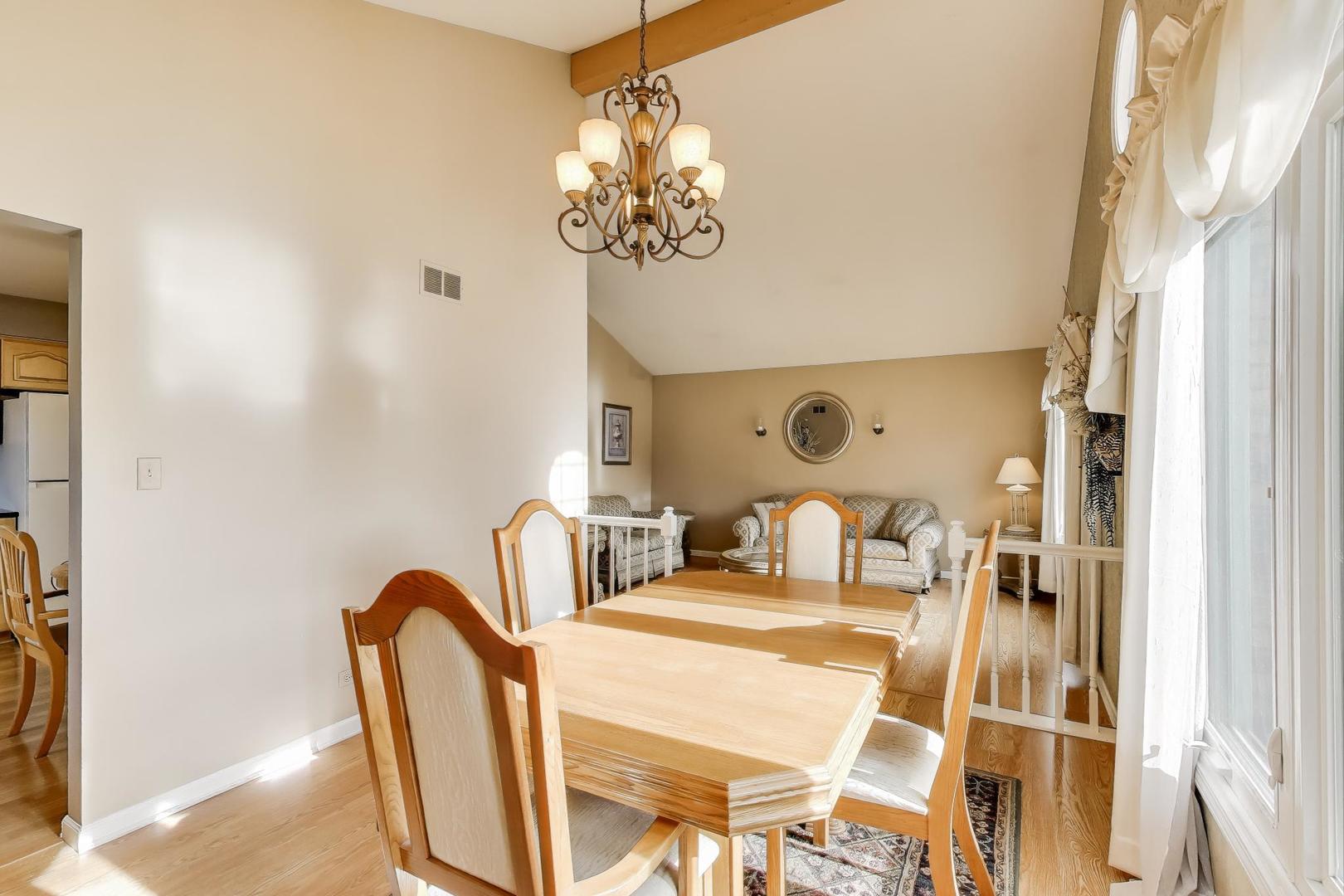 1407 Wilson Avenue Wheaton, IL 60189 - Photo 10 of 31 a dining room with furniture and a chandelier