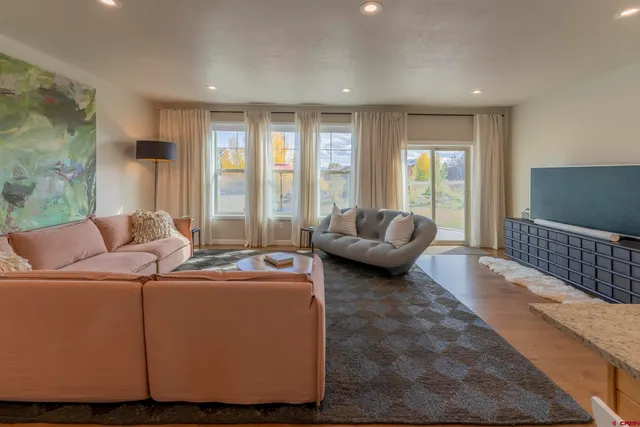 a view of a dining room with furniture and wooden floor
