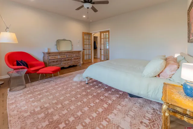 a bathroom with a granite countertop double vanity sink and a mirror