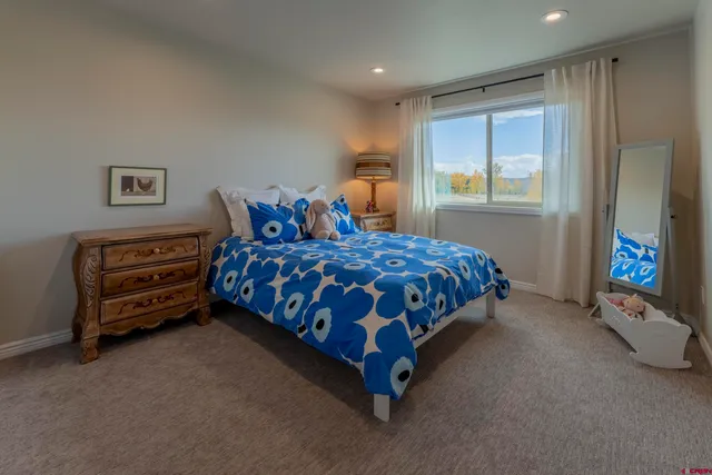 a bedroom with furniture and a window