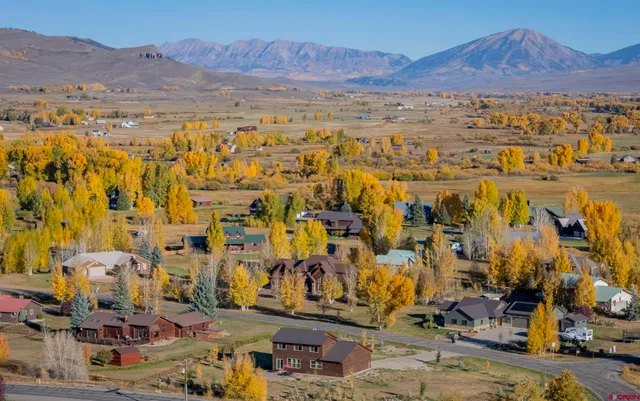 a red brick house with trees in front of it