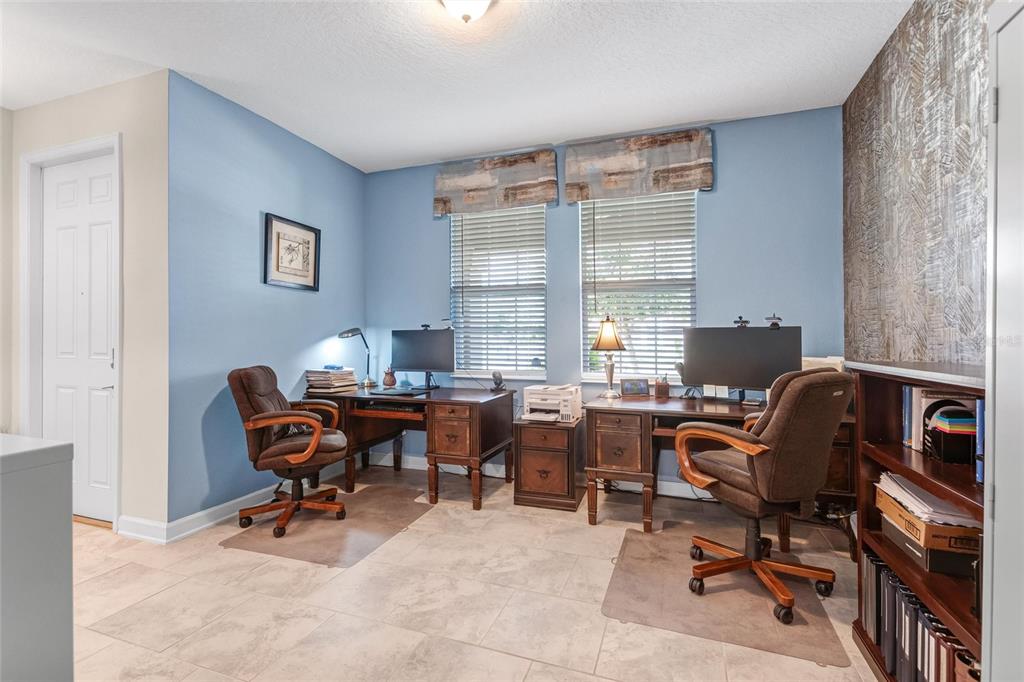 1089 Blackwolf Run Road Davenport, FL 33896 - Photo 6 of 82 a workspace with computers on a desk and chair