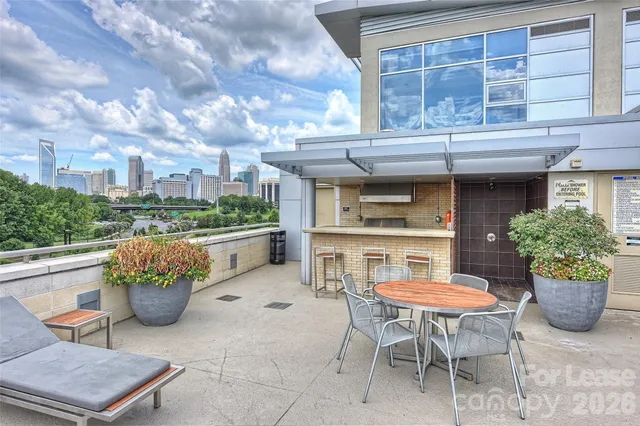 a view of a patio with table and chairs and a potted plant