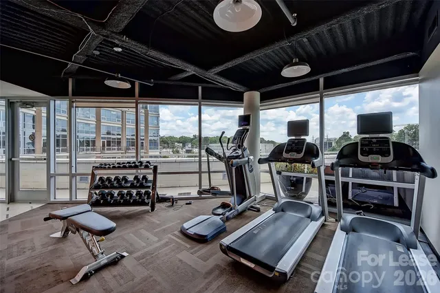 a room with gym equipment and a large window