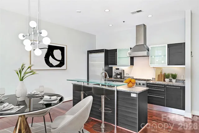 a kitchen with sink cabinets and dining table