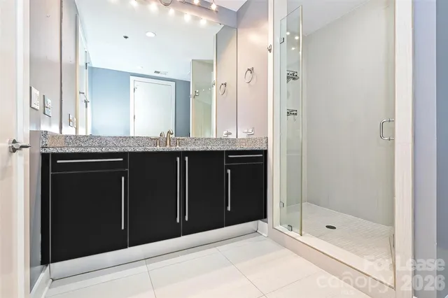 a bathroom with a shower and a sink